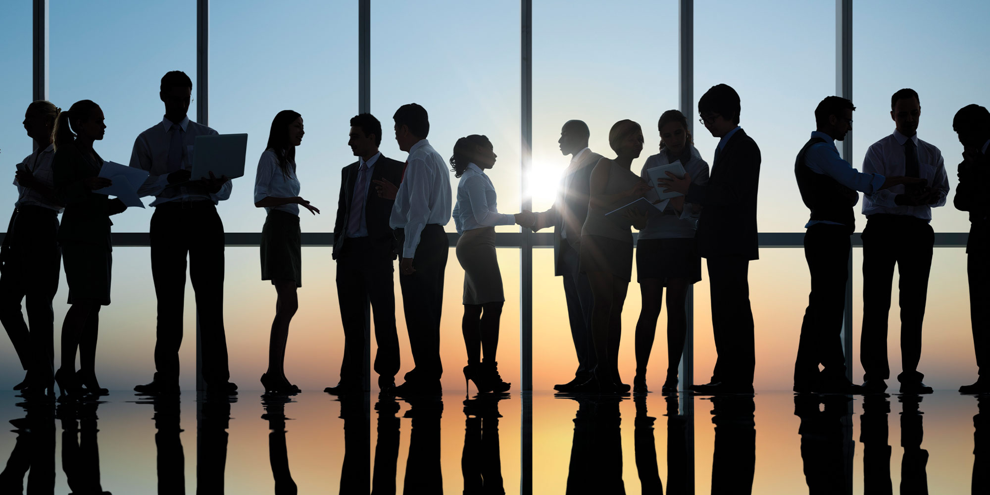 silhouette of business people standing in front of a window