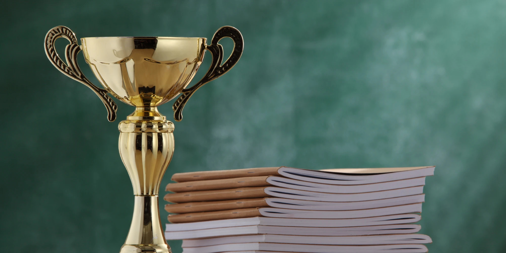 trophy beside a stack of journals