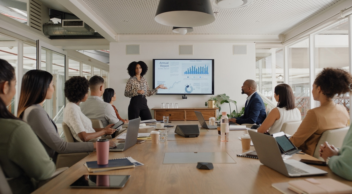 Business people, meeting and presentation on screen for data analytics, statistics and financial growth in boardroom. Professional leader, woman or analyst with monitor for graphs, charts and report
