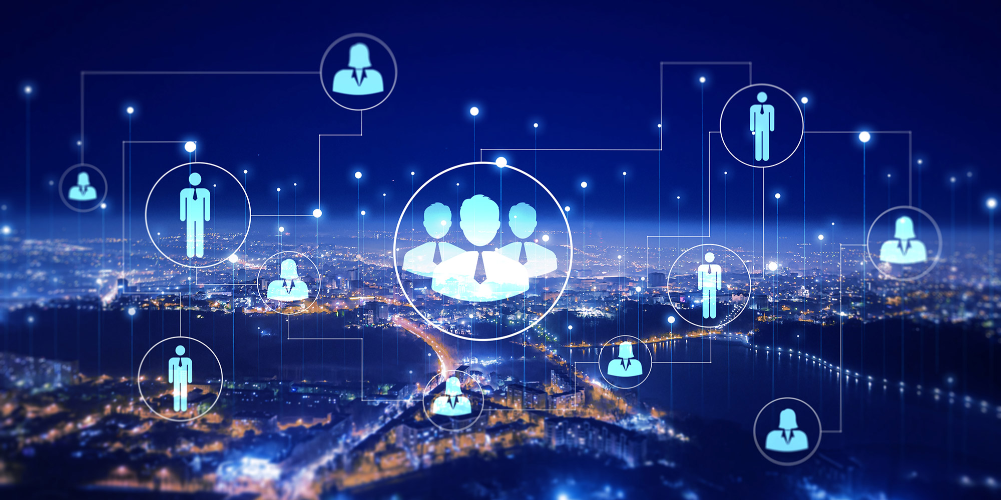 graphics of business men and women floating over aerial city view at night