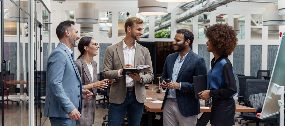 Multiethnic group of business people talking in office during break. Teamwork concept