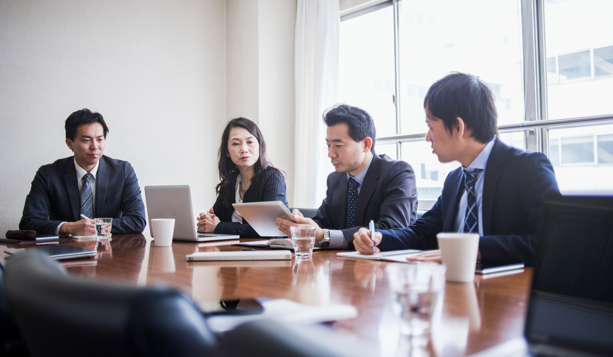 Four businesspeople meeting in a conference room.