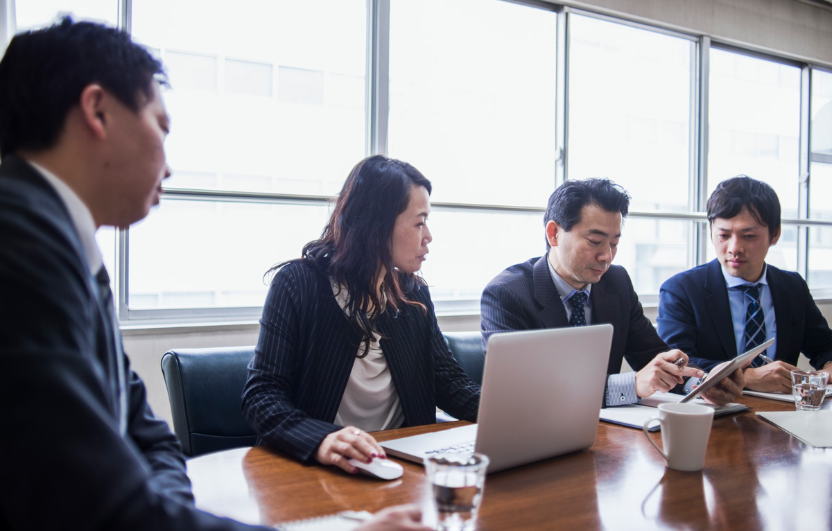 Male boss is in progress a meeting while using a digital tablet.