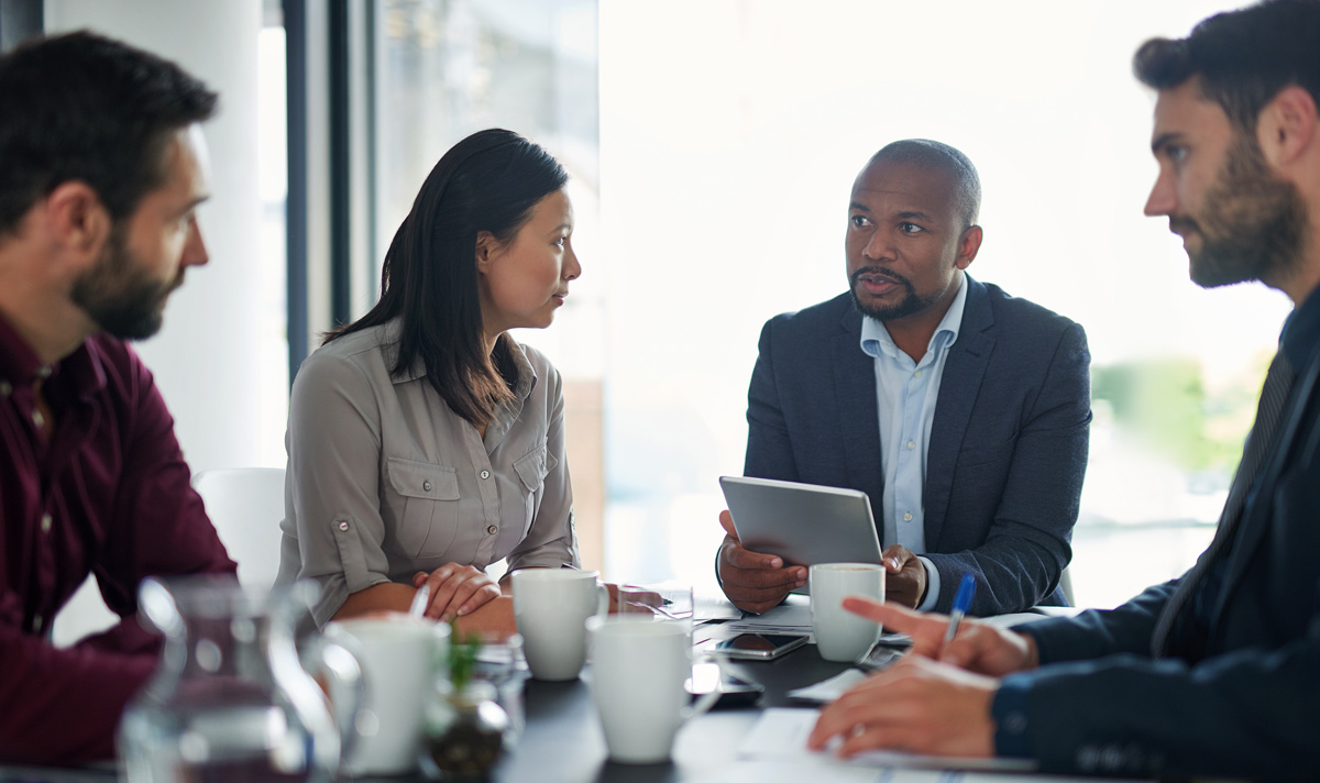 Cropped shot of a group of businesspeople sitting in a meeting