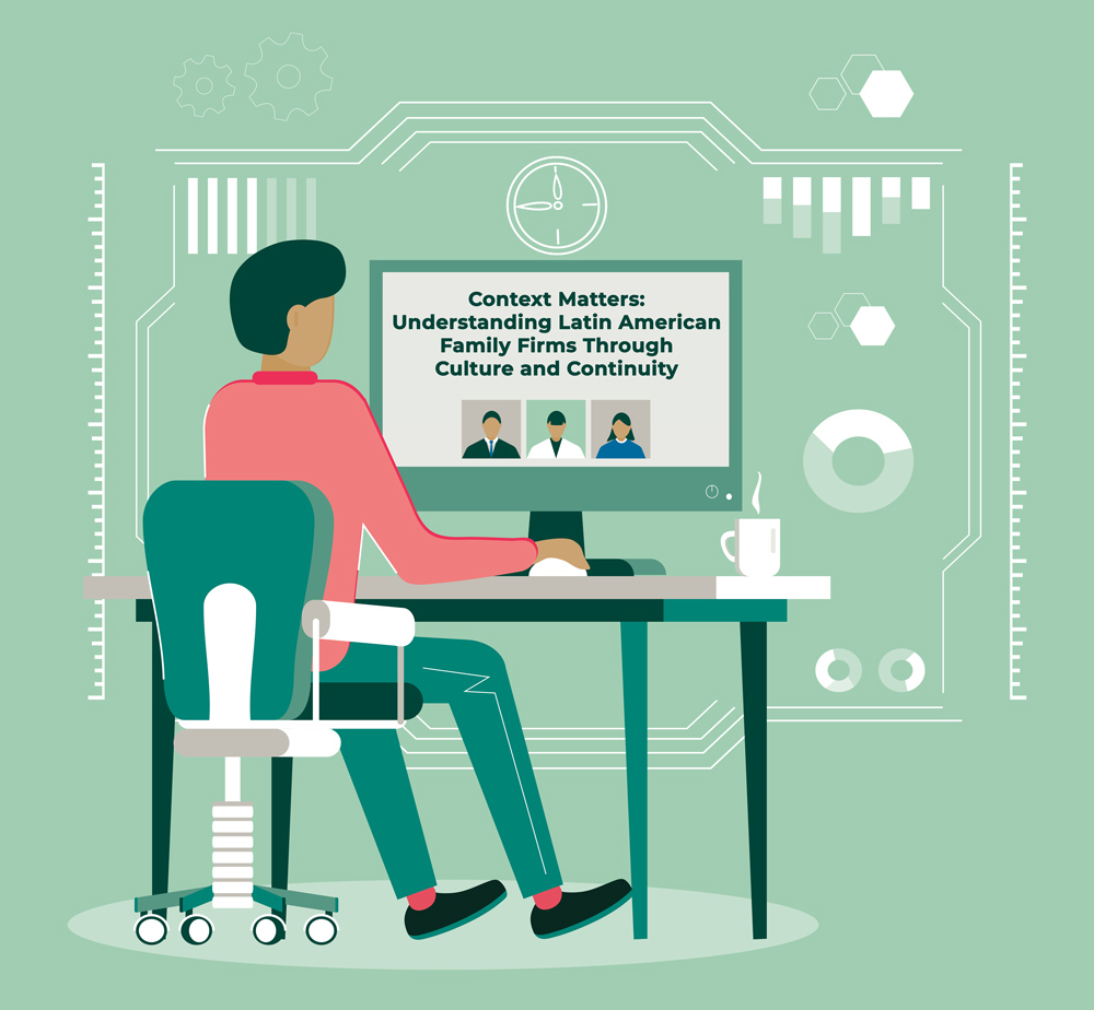 Person at a desk working on a computer with a digital display surrounded by abstract geometric designs.