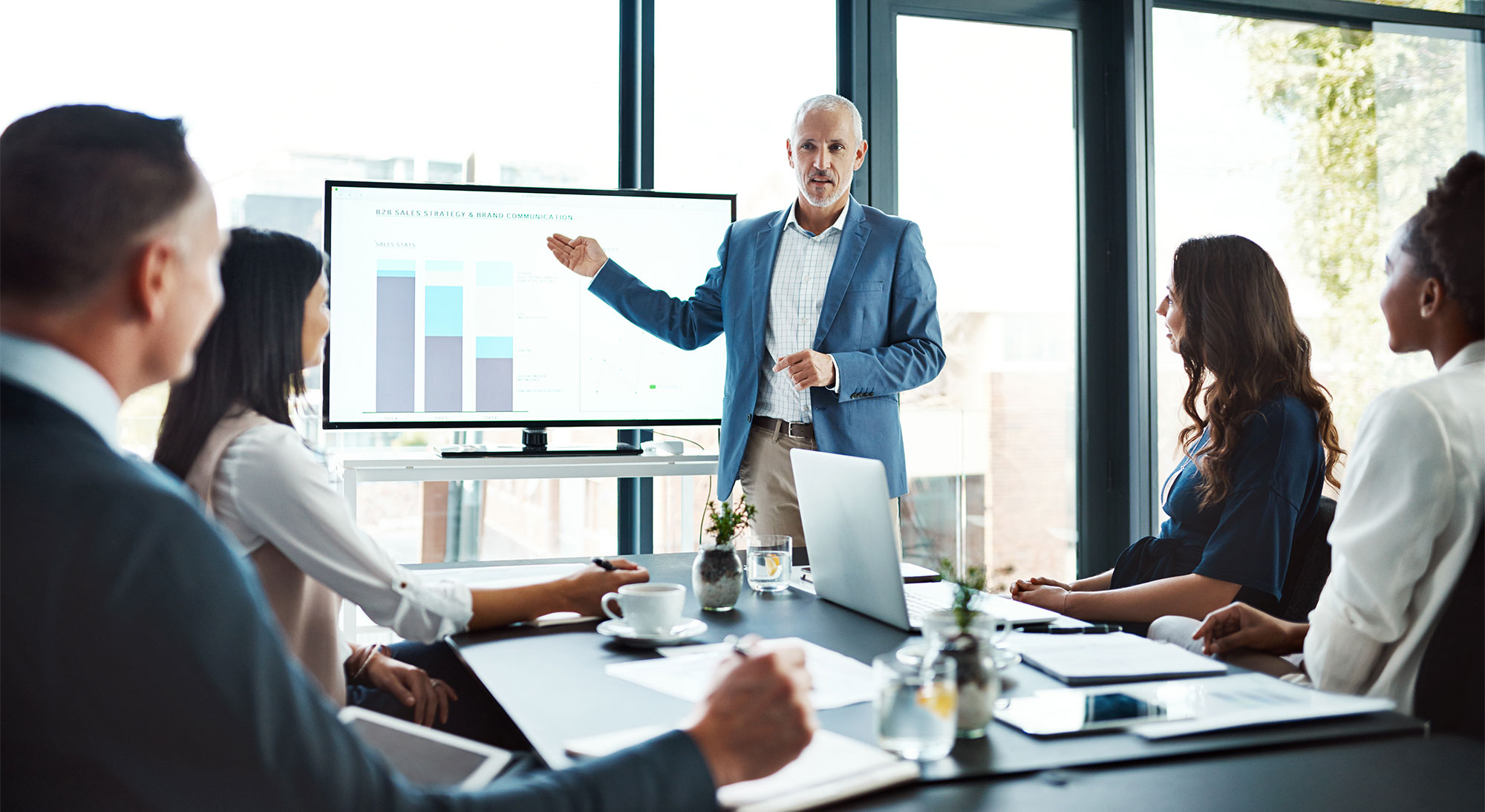 Education, training or learning on screen in business boardroom meeting to analyze data, chart or report. Manager with team of motivated executives in workshop presentation to plan vision or strategy