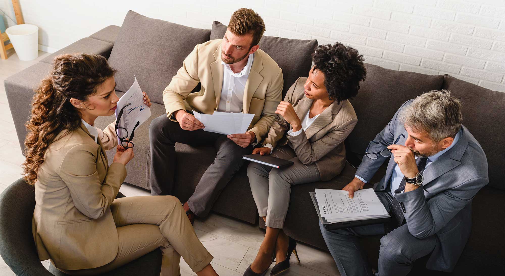 Business people having informal meeting in office. Diverse team discussing work. 